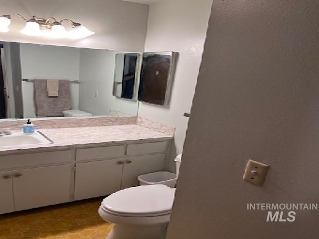 bathroom featuring toilet and vanity