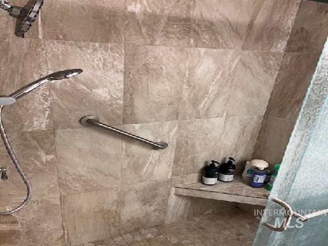 bathroom with a tile shower