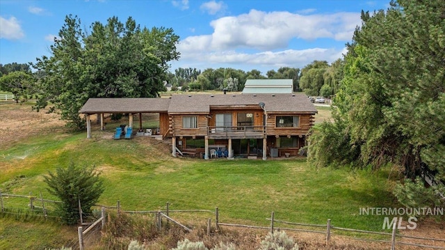 back of property featuring a rural view and a deck