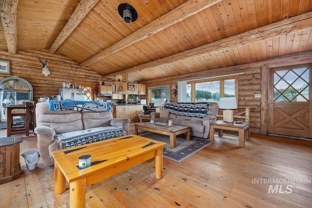 living room with vaulted ceiling with beams, light hardwood / wood-style floors, wooden ceiling, and rustic walls