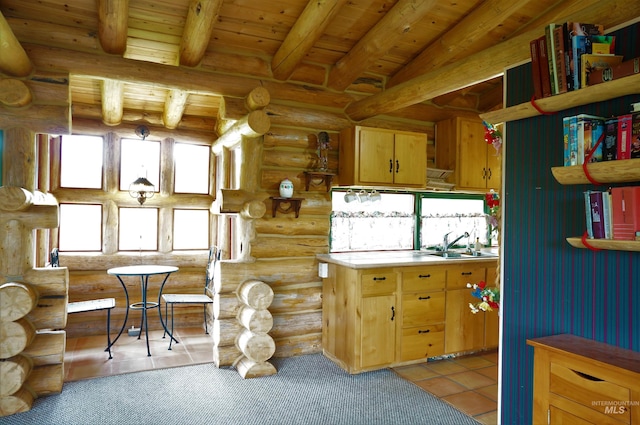 kitchen with log walls, light tile floors, vaulted ceiling with beams, sink, and wooden ceiling