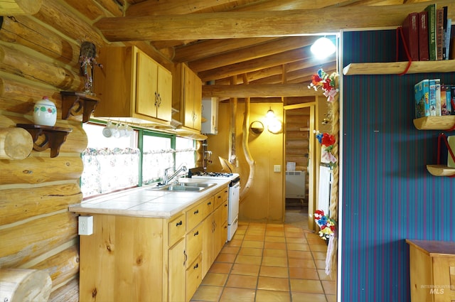 kitchen with tile counters, vaulted ceiling with beams, gas range gas stove, sink, and light tile floors