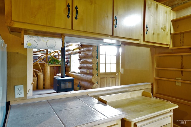 interior space featuring a wood stove and rustic walls