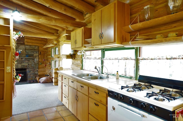 kitchen featuring white range, a stone fireplace, sink, log walls, and light tile floors