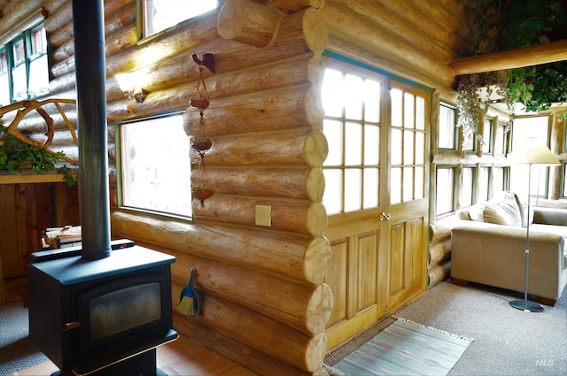 interior space with plenty of natural light and a wood stove