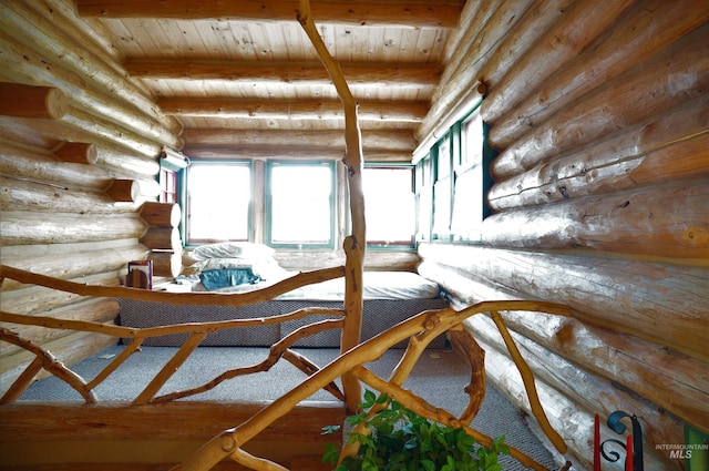 hallway with wood ceiling, beam ceiling, and rustic walls