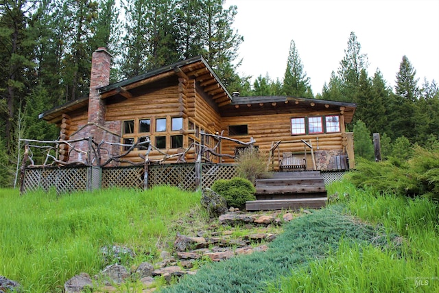 back of house with a wooden deck