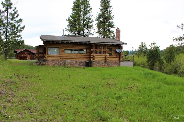 rear view of property with a yard