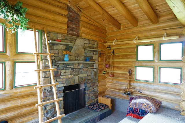 living room featuring vaulted ceiling with beams, wooden ceiling, a stone fireplace, and rustic walls