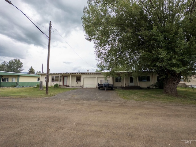 300 S Morgan Ave, New Meadows, ID 83654 - ranch-style house with an attached garage, asphalt driveway, and a front lawn