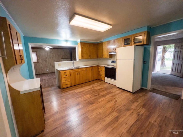 300 S Morgan Ave, New Meadows, ID 83654 - kitchen with white appliances, exhaust hood, light countertops, wood finished floors, and brown cabinetry