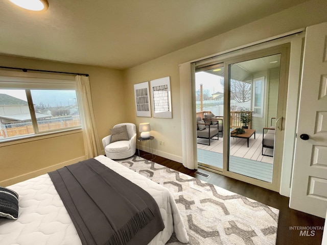 bedroom with wood-type flooring and access to outside