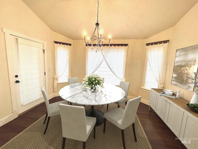 dining space featuring lofted ceiling, a notable chandelier, dark hardwood / wood-style flooring, and a wealth of natural light