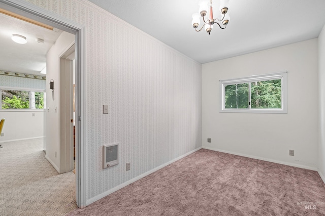 1718 Warren Wagon Rd, Mccall, ID 83638 - carpeted empty room featuring heating unit, a chandelier, and baseboards