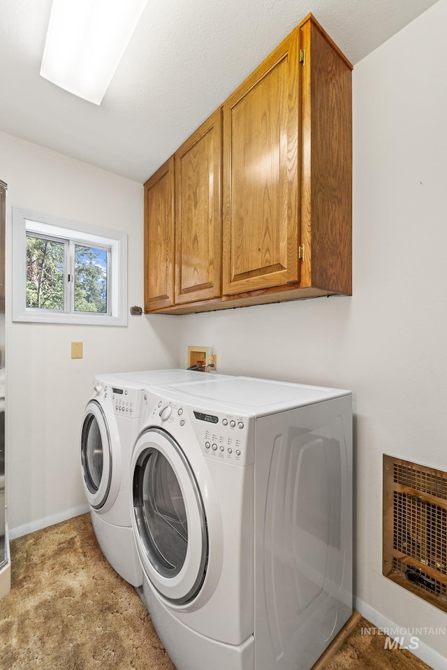 1718 Warren Wagon Rd, Mccall, ID 83638 - laundry room with cabinet space, separate washer and dryer, baseboards, and carpet flooring