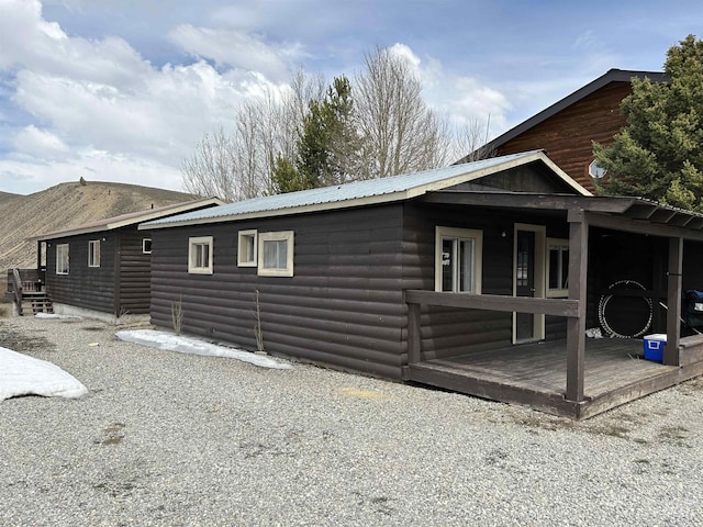 1150 Eva Falls Ave, Stanley, ID 83278 - view of home's exterior featuring faux log siding, a mountain view, and metal roof