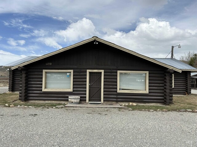 1150 Eva Falls Ave, Stanley, ID 83278 - cabin featuring log exterior, metal roof, and a barn
