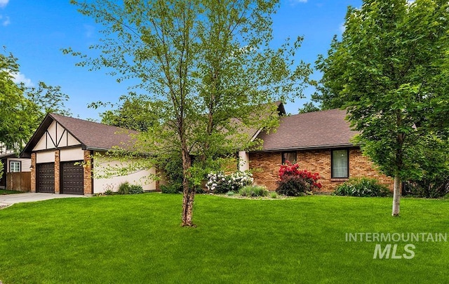 11151 W Hinsdale St, Boise, ID 83713 - view of front of home featuring a front lawn, a garage, brick siding, concrete driveway, and a shingled roof