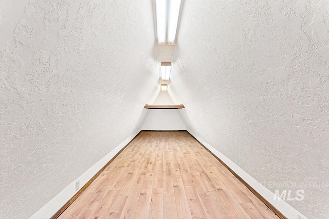 11151 W Hinsdale St, Boise, ID 83713 - unfurnished room with light wood-style floors, a textured wall, and baseboards