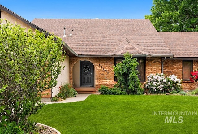 11151 W Hinsdale St, Boise, ID 83713 - view of front of home featuring brick siding, a front lawn, and roof with shingles