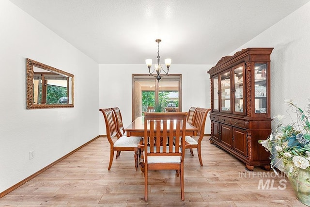 11151 W Hinsdale St, Boise, ID 83713 - dining area with a chandelier, light wood-type flooring, and baseboards