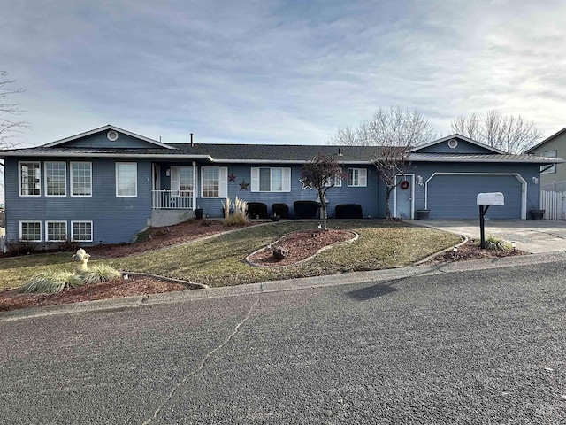 single story home featuring a garage and a front lawn