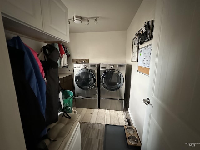 washroom with cabinets, hardwood / wood-style flooring, and independent washer and dryer