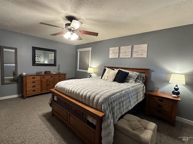 carpeted bedroom with ceiling fan and a textured ceiling