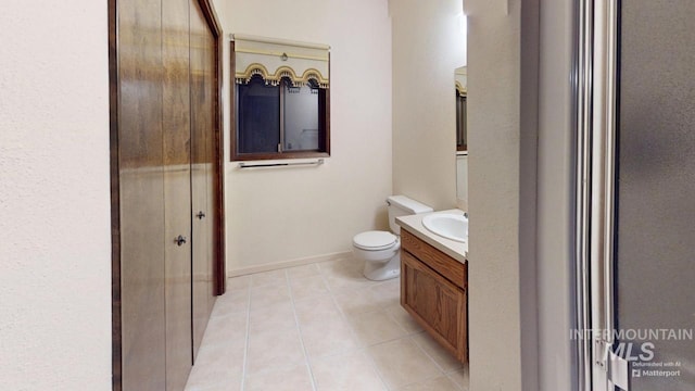 bathroom with vanity, tile patterned flooring, and toilet