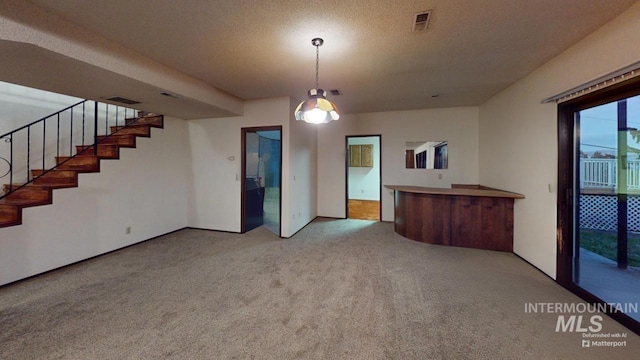 interior space with carpet flooring and a textured ceiling