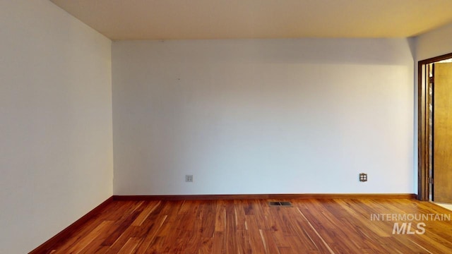 unfurnished room featuring dark wood-type flooring