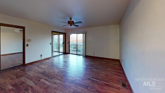 unfurnished room featuring ceiling fan and dark hardwood / wood-style flooring