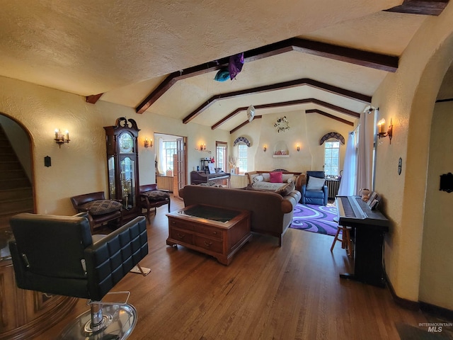 bedroom featuring lofted ceiling with beams, a textured ceiling, and dark hardwood / wood-style floors