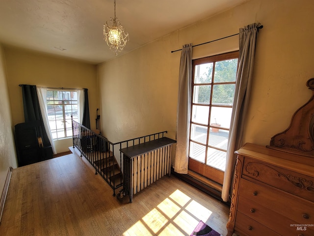 bedroom featuring light wood-type flooring and an inviting chandelier