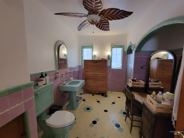 bathroom featuring tile walls, tile patterned flooring, toilet, and ceiling fan