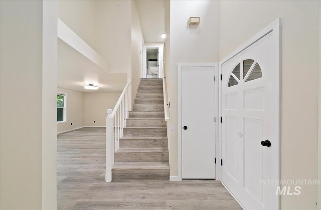 staircase with wood finished floors and baseboards