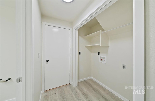 washroom featuring light wood-style flooring, hookup for a washing machine, hookup for an electric dryer, and baseboards
