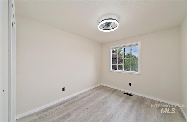 unfurnished room featuring light wood-style flooring and baseboards
