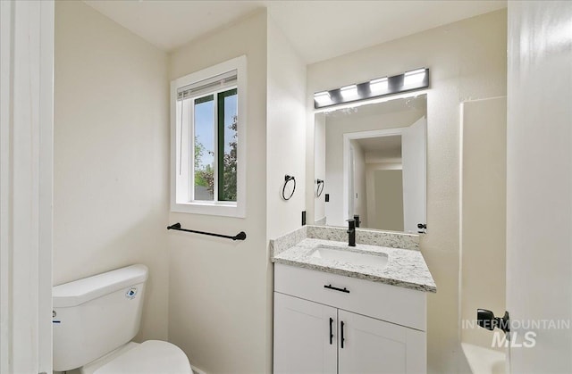 bathroom featuring toilet and vanity