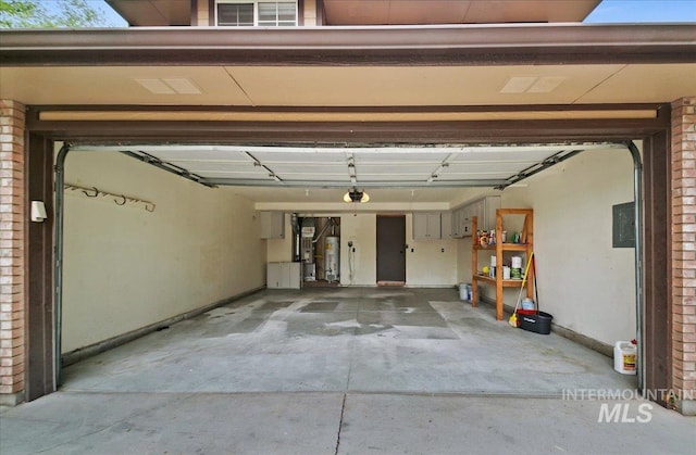 garage featuring water heater, a garage door opener, baseboards, and electric panel