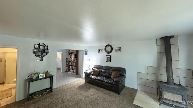 living room with a wood stove and carpet flooring