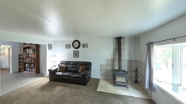 carpeted living area featuring a wood stove