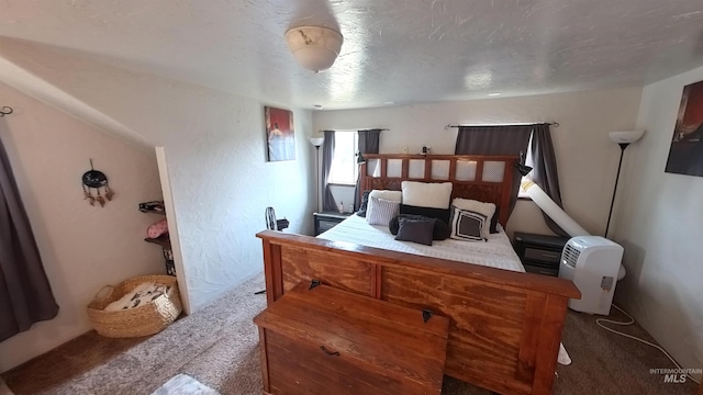 bedroom with a textured ceiling and carpet floors