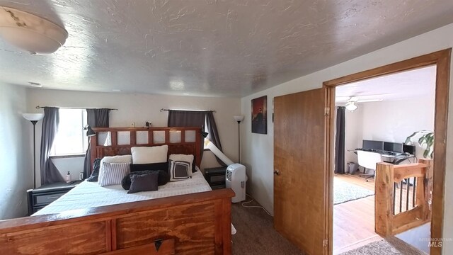 bedroom featuring a textured ceiling and carpet floors