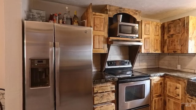 kitchen with stainless steel appliances and backsplash