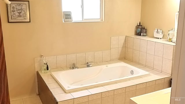 full bathroom with tile patterned flooring, baseboards, and a bath