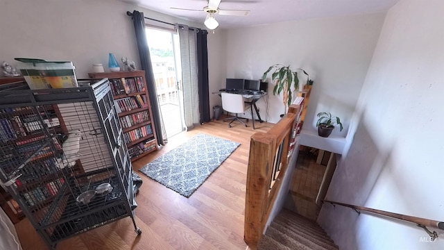 home office with a ceiling fan and wood finished floors