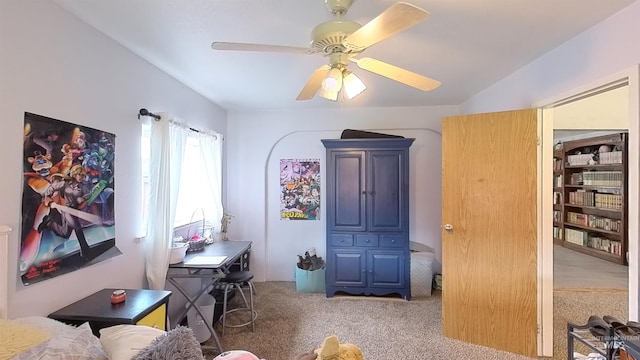 interior space featuring a ceiling fan and carpet