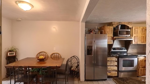 kitchen featuring under cabinet range hood and stainless steel appliances