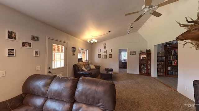 carpeted living room with lofted ceiling and ceiling fan with notable chandelier